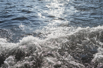 Water surface with ripples and sunlight reflections