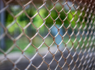 Fototapeta premium Close-up chain link fence , Sunset background