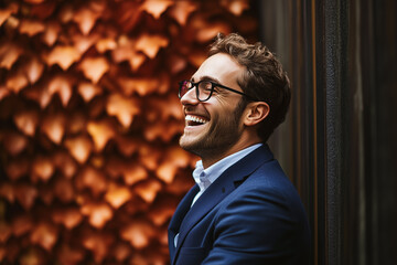 Fototapeta premium Smiling Man in a Suit Enjoys a Moment Outdoors Near Vibrant Autumn Leaves in an Urban Setting