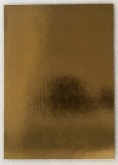 real photo, laminated gold foil paper print behind protection layer, the camera is reflected in the...