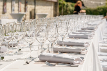 Served wedding table with plates, white chairs, napkins and wine glasses
