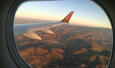 view out of an airplane window showing an airplane wing, 