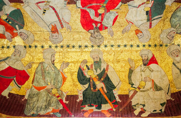 Obraz premium detail of painting and gold leaf with an Arabic and Moorish style scene on a vaulted ceiling of the Nasrid palaces of the Alhambra, Granada, Spain