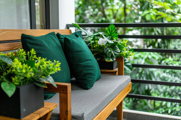 A stylish balcony setup featuring a wooden bench with deep green pillows, complemented by vibrant potted plants and orchids, offering a peaceful and refreshing outdoor space.  
