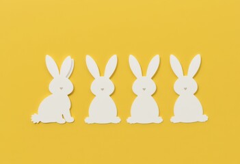 Obraz premium Four white bunny cutouts on yellow background.