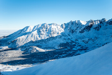 Tatra mountains at winter time. View of the white snow-capped peaks, frosty winter mountains. Kasprowy Wierch, High Tatra, Poland, Europe.