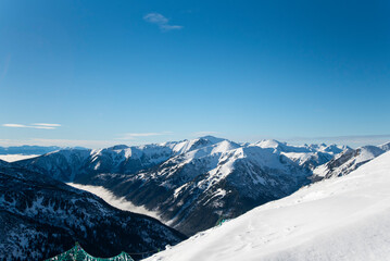 Fototapeta premium Tatra mountains at winter time. View of the white snow-capped peaks, frosty winter mountains. Kasprowy Wierch, High Tatra, Poland, Europe.