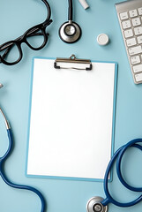 MOCKUP - blank clipboard on a doctors desk with medical equipment arounds