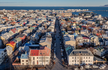 Reykjavík city skyline buildings along the coastline of the Atlantic ocean. Photo taken in Iceland on a sunny day