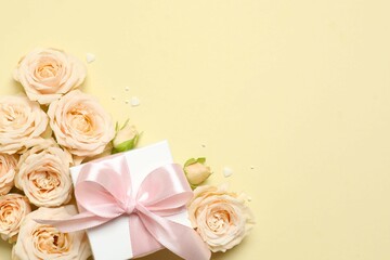 Beautiful composition with peony roses and gift box on color background