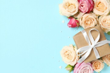 Beautiful composition with peony roses and gift box on color background