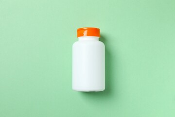 White bottle on a green background
