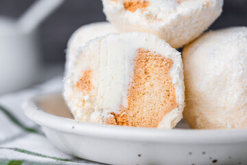 Coconut ice cream on a white plate, selective focus.