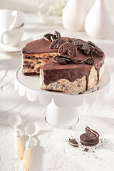 Tasty and homemade cheesecake with cookie and chocolate glaze.