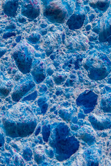 Close-up of the surface of a blue kitchen sponge