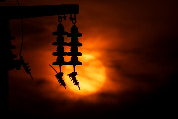 Electricity pole silhouette at sunset