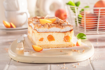 Tasty and delicious cheesecake with peaches and cocoa and fruits.