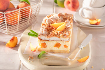 Homemade and sweet cheesecake with peaches and cocoa foam.