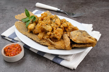 Gurame Saos Telur Asin. Crispy fried gourami fish covered with salted egg sauce. Indonesian food
