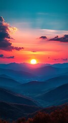 Obraz premium Majestic sunset over rolling hills and mountains.