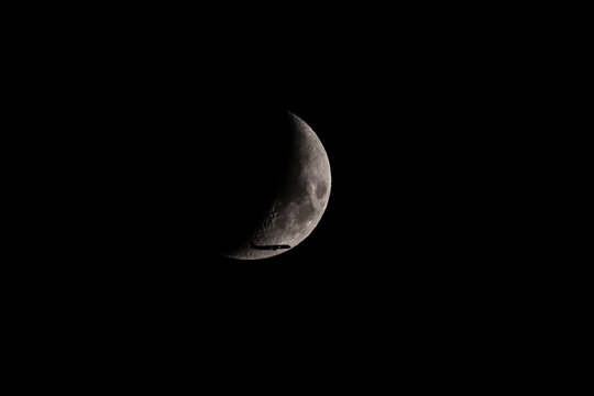 Silhouette of an Airplane in front of Moon
