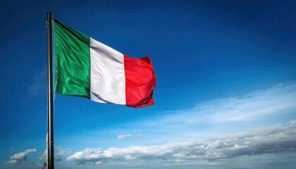 A vibrant Italian flag waves proudly on a pole, set against a bright blue sky with soft clouds. This display evokes a sense of national identity and connection to the global community