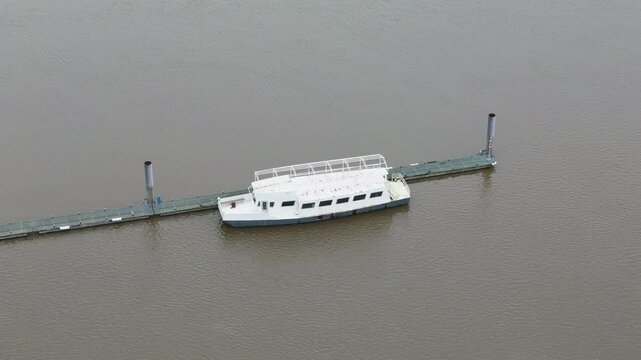top abandoned passenger river transport boat or pleasure ferry ship vessel appears to be dilapidated state circling aerial drone shot view temse belgium 