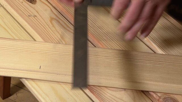 Marking of wooden plank with steel square for later cutting