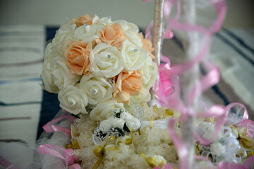 Biedermeier and flower bows in a basket for decorating guests at a wedding