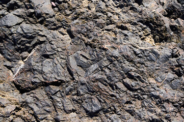 Detailed close-up of rugged geological formations in a rocky landscape captured on a sunny day
