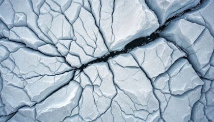 Aerial view of cracked arctic ice sheets displaying natural patterns and textures