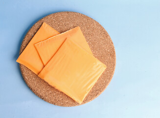 pieces of american cheese on a blue background