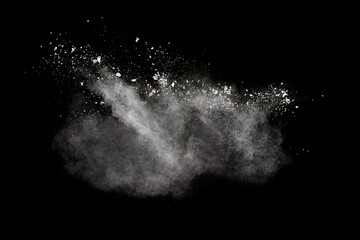 White powder explosion isolated on black background.White dust particles splash.
