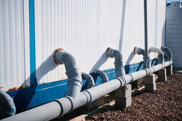 Junction of plastic sewer pipes. Sewage pipeline system of industrial prefabricated building 