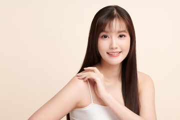 Fototapeta premium Beautiful young asian woman with clean fresh skin on beige background, Face care, Facial treatment, Cosmetology, beauty and spa, Asian women portrait.