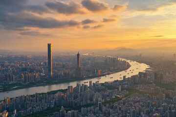Urban skyline reflecting in calm water during late afternoon with clouds in the sky
