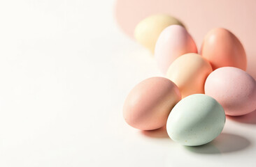 In the right are eggs, with free space for text on the left of image, pastel colors eggs, pattern on the eggs, white background.