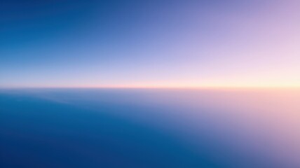 Obraz premium A breathtaking gradient sky transitions from deep blue to soft pink at the horizon, creating a serene and tranquil atmosphere.