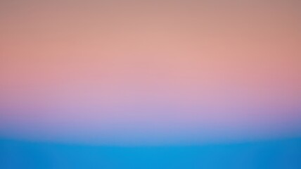 Obraz premium A serene gradient of pastel colors transitioning from soft pink to calming blue, evoking a tranquil atmosphere and peaceful mood.
