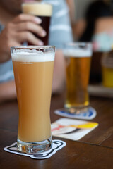 2 Glasses of beer with blur background of a guy drinking beer