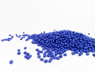 Blue masterbatch plastic granules, polymer carries colorful pigments poured into a white background, suitable for product catalog design of industrial plastic manufacturing company profiles