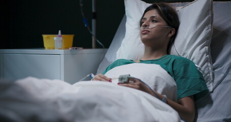 Patient slowly wakes up, and a doctor enters the room, placing medication on the table.