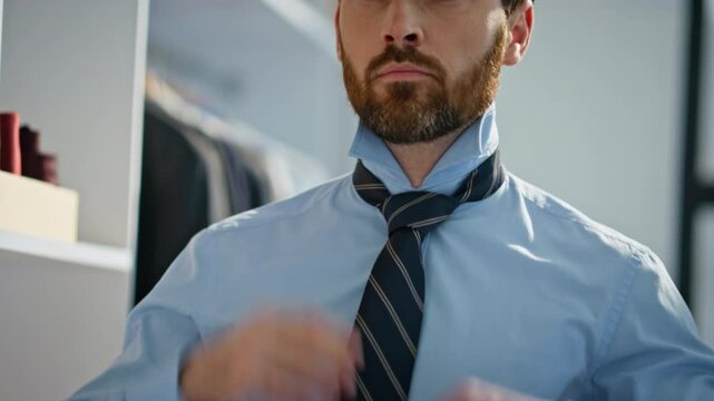 Closeup businessman correcting tie preparing for work at home. Man getting ready