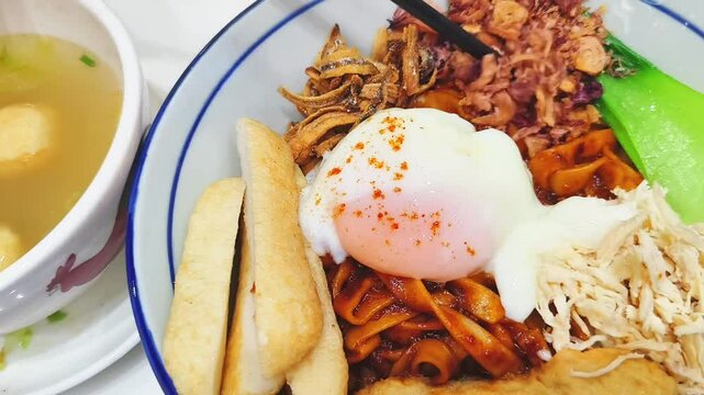 A fried mee with fried eggs of a Chinese cuisine