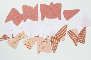 machine-cut decorative paper segments or wedges arranged on blank paper