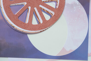 pile of cart wheel shapes machine-cut from decorative scrapbooking paper and arranged with circle...