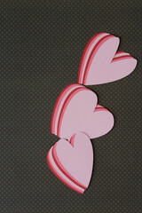 machine-cut layered hearts on dark brown paper with dot pattern