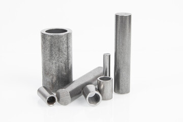 Mechanical engineering and metalworking. Metal parts rollers and bushings on white background