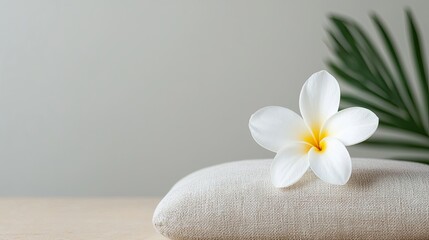 Serene White Flower Resting on Natural Cushion with Green Leaf in Tranquil Meditation Space