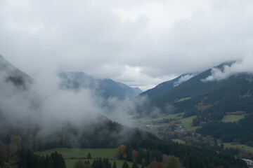 Mountain valley fog lifting over forests and meadows
